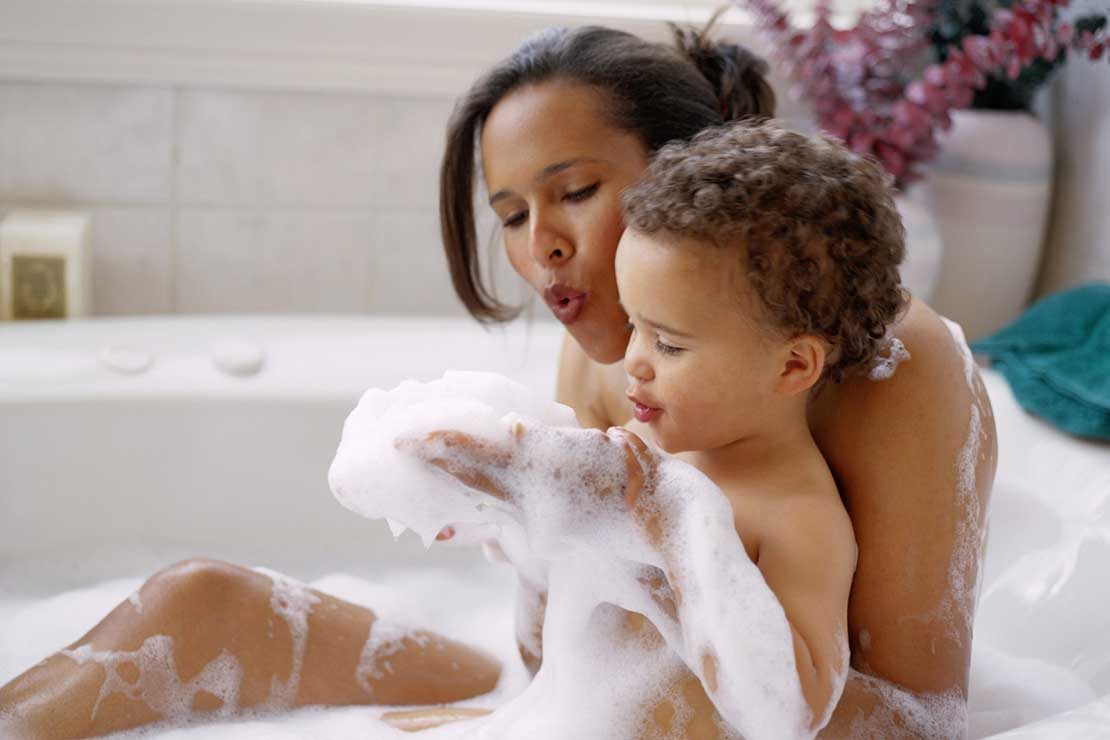 A mother and child enjoying a bubbly bath together